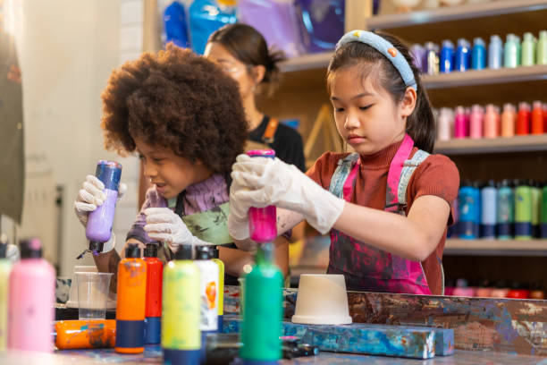 istock Group of Diversity school children learning acrylic art together in art class. 1903748681