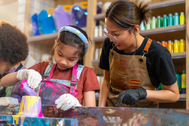 istock Group of Diversity school children learning acrylic art together in art class. 1903749200