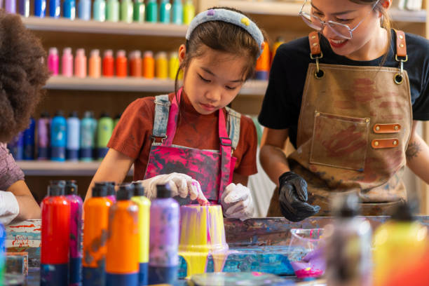 istock Group of Diversity school children learning acrylic art together in art class. 1903749443