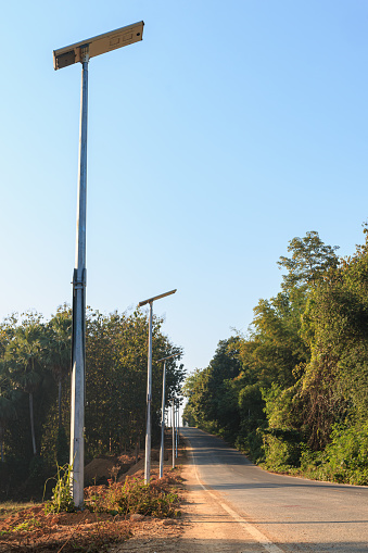 Street light against evening blue sky background.