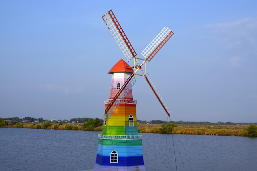 A rainbow windmill on the canal