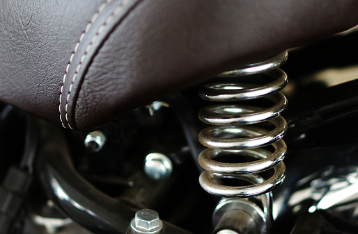 Close-up view of seat of a motor bike with springs for cushion effect