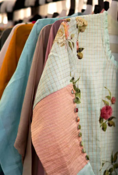 Photo of view of Indian woman wear kurtis hung in shop display