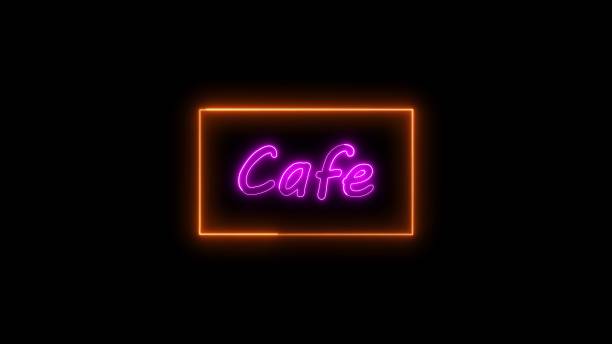 istock Neon cafe sign glowing in vibrant pink and orange colors against a dark background. 1903918361