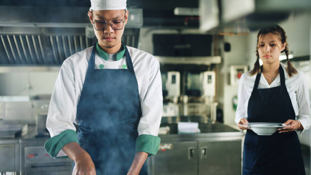 cooking together. - chef trainee cooking teenager imagens e fotografias de stock