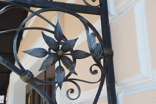 A low look up to a gate with a sky backdrop.