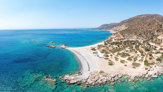 Crete island, Greece. Aerial drone panoramic view of beach at Palaiochora town, transparent crystal clear sea water, blue sky, rocky formation.