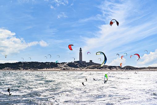 Young girl windsurfing in a blue sea in a summertime.