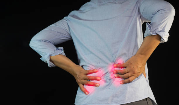 istock Close-up of hands touching back pain. 1903981061