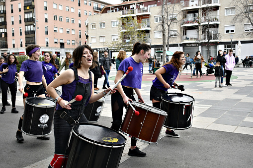 Igualada, Barcelona; March 8, 2020: celebration of Women's Day with the batucada group Protons Percussion, playing through the streets of Igualada