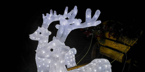 istock Two glowing deer with a cart in the backyard 1903998217