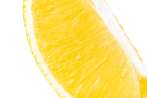 Close-up of cut lemon isolated on white background.