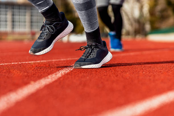 istock Close up of runner feet running on track. 1904023439