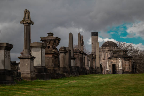 istock Glasgow necropolis on a cloudy and sunny day, large picturesque graveyard on a hill above Glasgow with many magnificent tombstones 1904037282