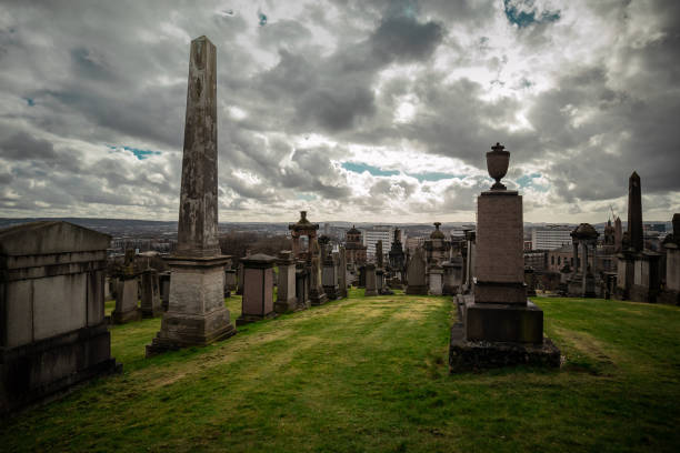 istock Glasgow necropolis on a cloudy and sunny day, large picturesque graveyard on a hill above Glasgow with many magnificent tombstones 1904037295