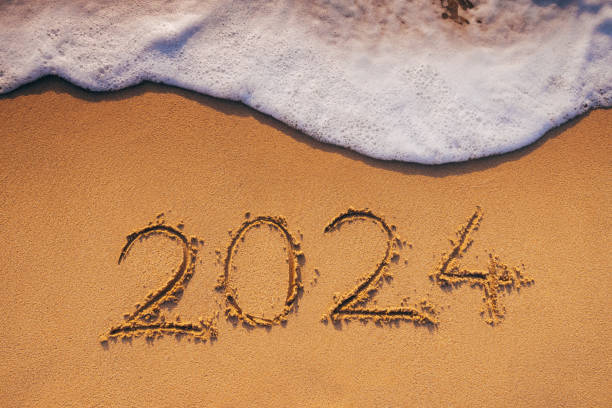 istock 2024 text in sea sand and wave at ocean beach shore 1904045704