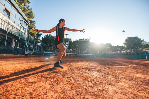 Baseball, sport and ball with a sports woman, athlete or pitcher throwing and pitching a ball during a game or match on a court. Fitness, workout and exercise with a female athete training outside