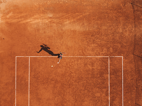Aerial view of a tennis match on clay court.