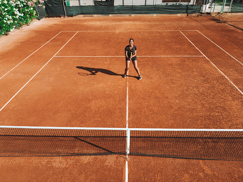 Aerial view of a tennis match on clay court.