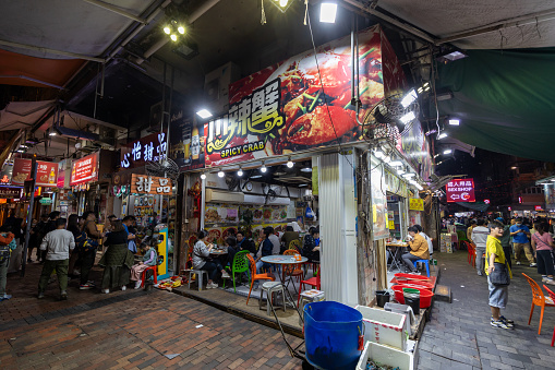 Hong Kong - December 31, 2023 : People at a spicy crab restaurant in Temple Street, Kowloon, Hong Kong.