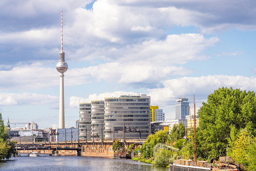 A view along a stretch of the Spree River in Berlin, looking towards the TV Tower on the horizon.
