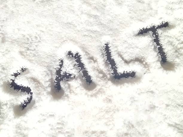 istock salt is written on white sand background 1904136682