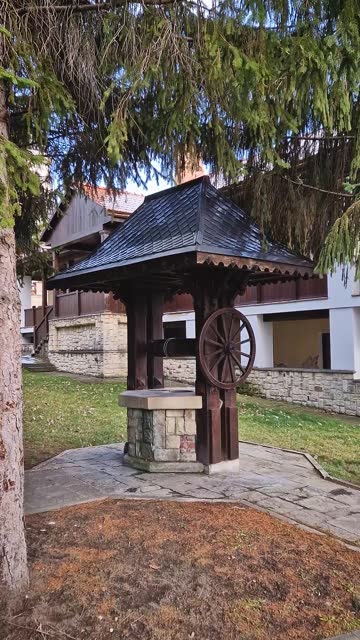 Traditional old well made of wood and stone, in the Capriana monastery courtyard, Moldova