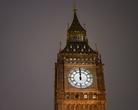 The clock face on Big Ben showing midnight.