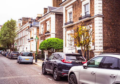 Detached and terraced brick-built houses on a street in South Kensington in West London.