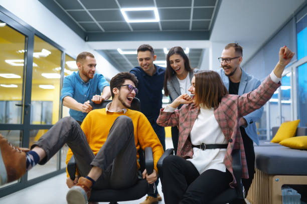 istock A group of young colleagues are having fun in the office corridor. 1904182285