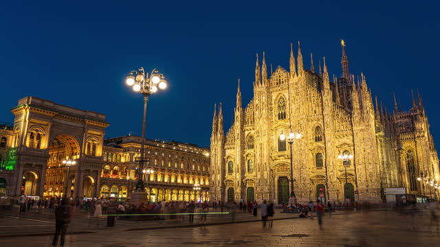 Day to night Time Lapse of Crowd of People tourism walking and sightseeing attraction at Milan Cathedral (Duomo di Milano) and galleria vittorio emanuele ii in Milan, Italy