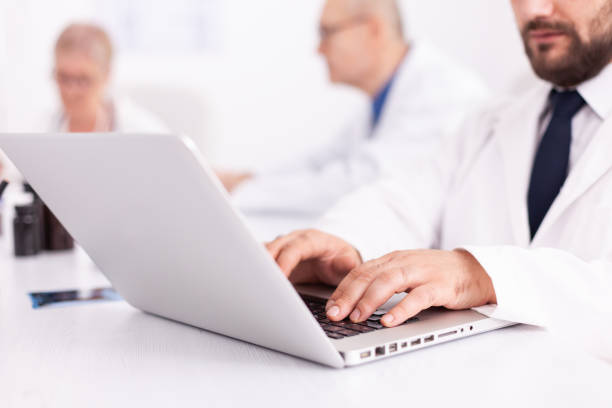 istock Young medical specialist typing on laptpp 1904220143
