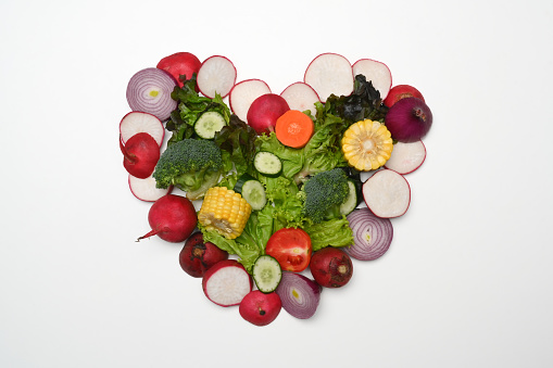 Heart made of various raw vegetables. Flat lay, top view and healthy food concept
