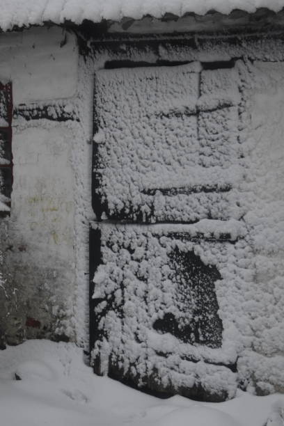 istock Snow sticking to an old stable door. 1904245401