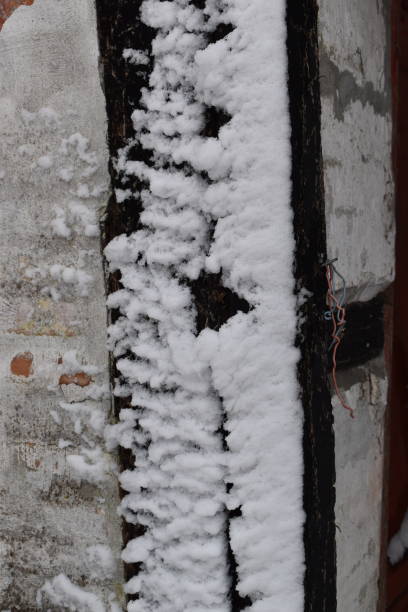 istock Half timbered house corner with sticking snow. 1904254358