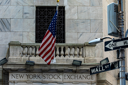 The New York Stock Exchange building on Wall Street, with its American flag that is known around the world.