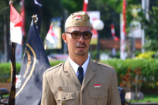 “Semarang, Indonesia – August 17, 2022 : The antique bicycle community held a Flag Ceremony during the commemoration of the independence day of the Republic of Indonesia in the Tugu Muda monument area, Semarang, Indonesia\