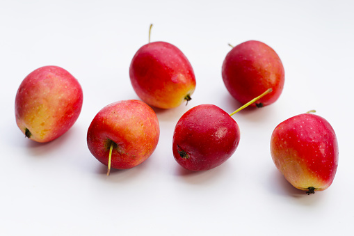 Fresh small red apples on white background