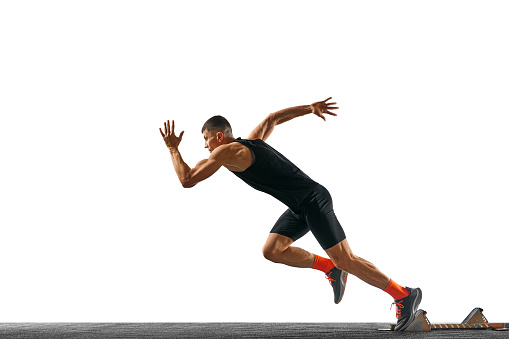 Side view full length portrait of young sportsman, professional runner runs up quickly against white background. Concept of sport, active lifestyle, action. Ad. Copy space for text.
