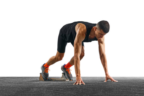 istock Young athletic man, professional jogger preparing to run while standing at low start against white pristine background. 1904315270