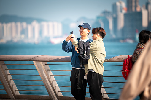 Hong Kong, 03 Jan, 2024: Tourists activity on Avenue of Stars. Massive tourist visits Hong Kong water-front in the new year of 2024