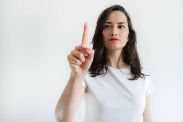 young woman pressing a virtual button - business pointing women index finger стоковые фото и изображения