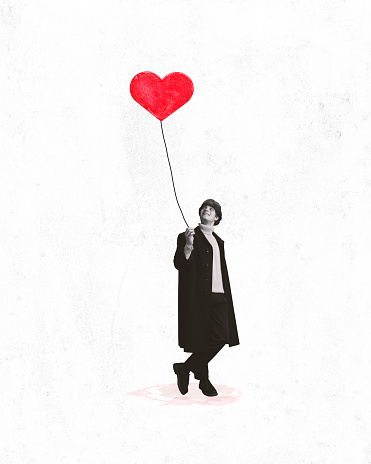 Poster. Contemporary art collage. Young charming man in black and white filter holds painted balloon that will give to his beloved. Concept of Valentine's Day, love, relationship, first date.