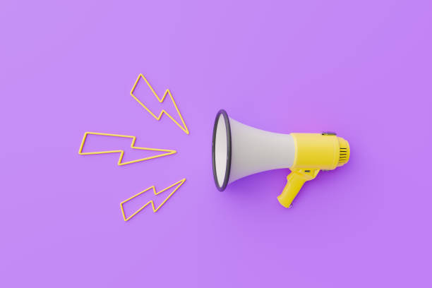 istock Yellow megaphone with lightning symbols on a purple background 1904393165