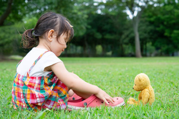 little girl playing with teddy bear