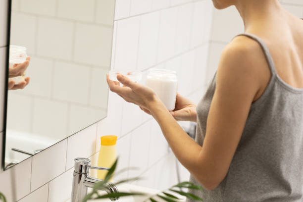 istock Woman in the bathroom using hand moisturizer 1904428398