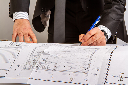 man hand is writing on building project cropped horizontal construction business still