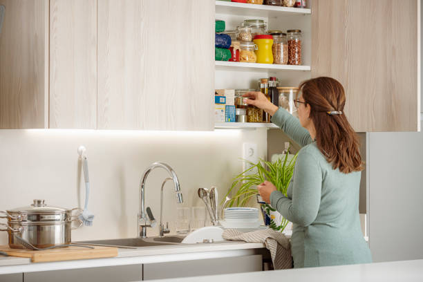 istock A woman is placing or picking groceries in kitchen pantry 1904466892