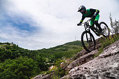 Sport. Cyclist against the sky. A young man rides a mountain bike in beautiful nature.Downhill, MTB. Extreme sport