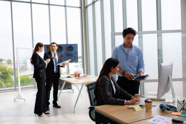 istock Asian businessperson colleagues discussing with computer in office. 1904484094